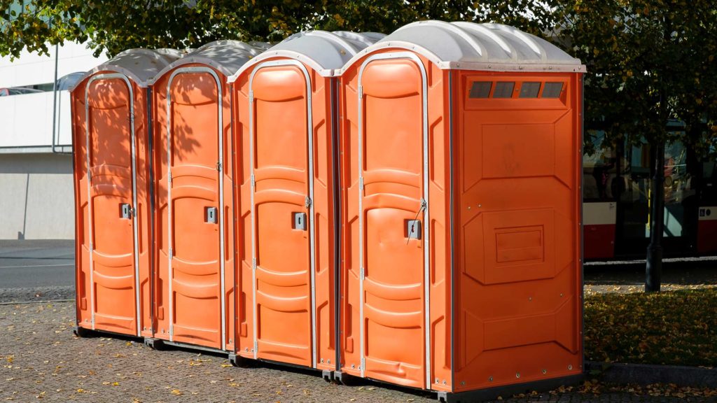 row of orange portable restrooms ware county ga